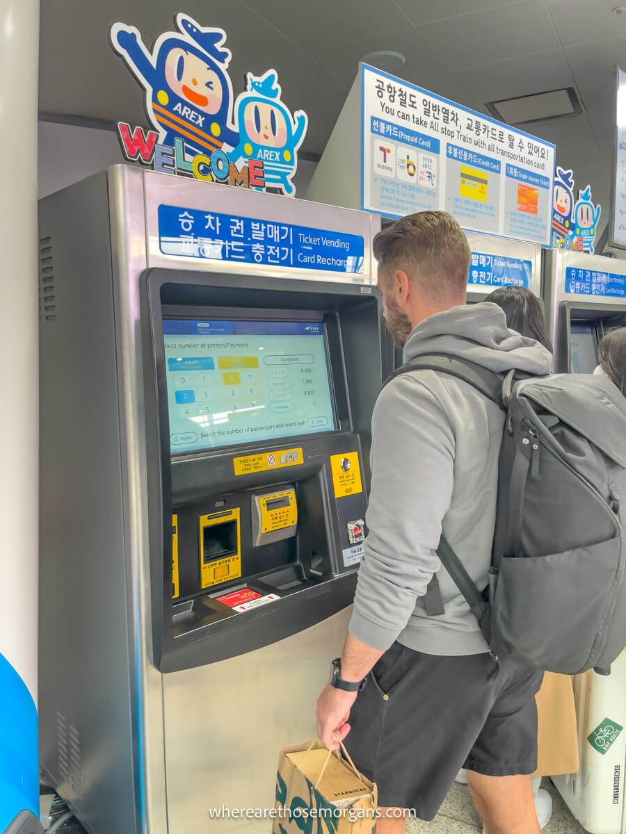 Man purchasing a ticket for the Seoul express train