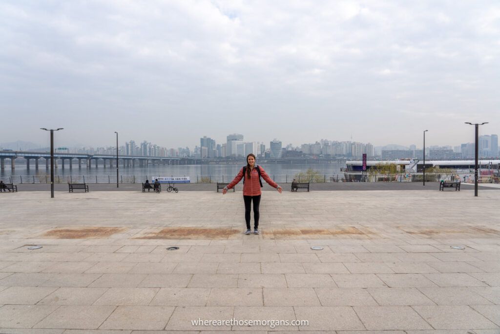 A woman standing along the Han River in Seoul