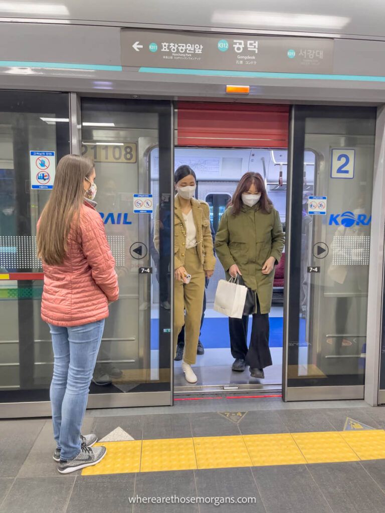 Tourist waiting patiently to get on a Seoul subway