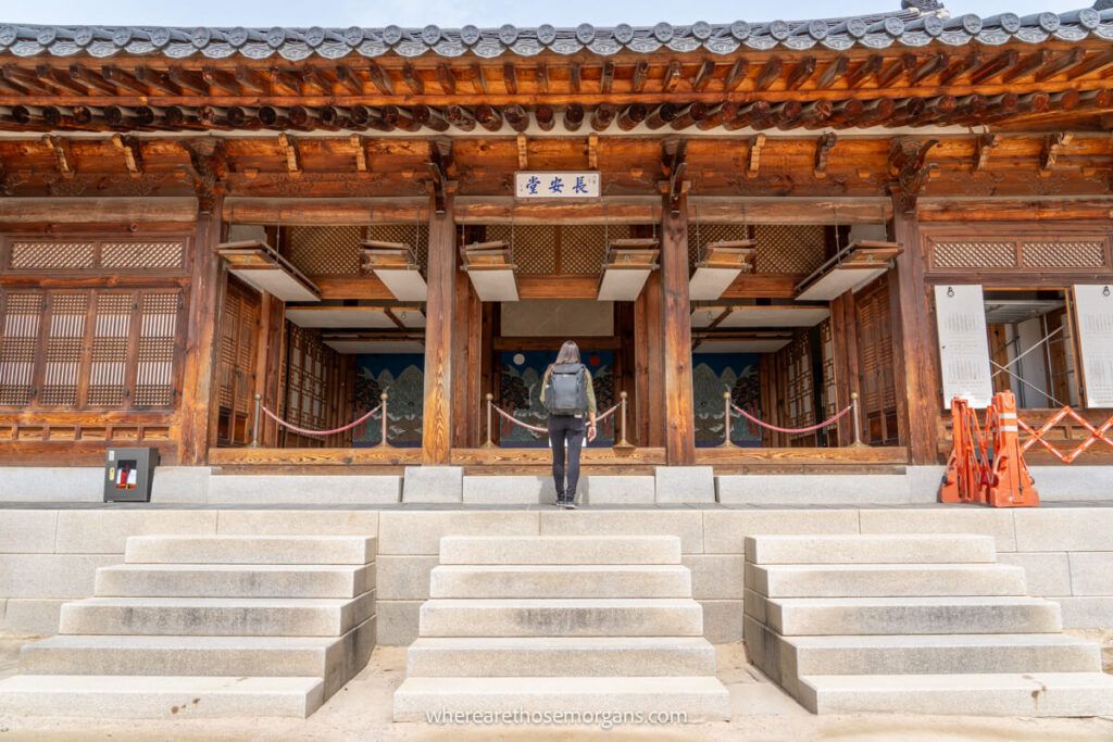 Woman peeing inside a beautiful wooden palace building in Seoul, South Korea