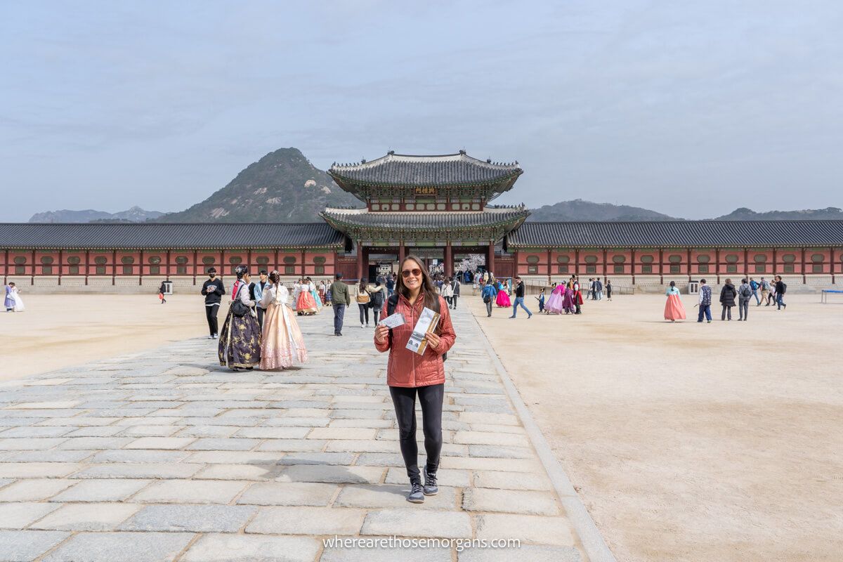 Woman posing with her entrance tickets for Gyeongbokgung in Seoul, South Korea
