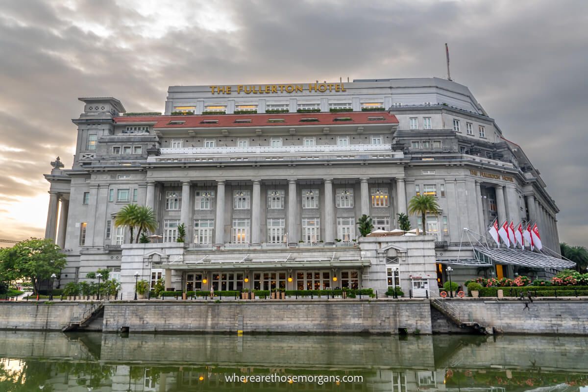 Grand hotel made of stone behind a river on a cloudy day