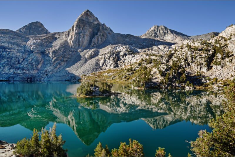 Rae Lakes Trail stunning reflection on still water in Sequoia and Kings Canyon California