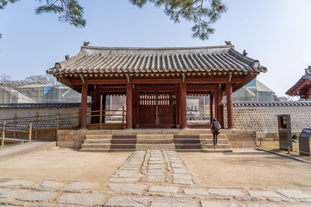 Woman walking up to the gate for Jeongjeon Hall