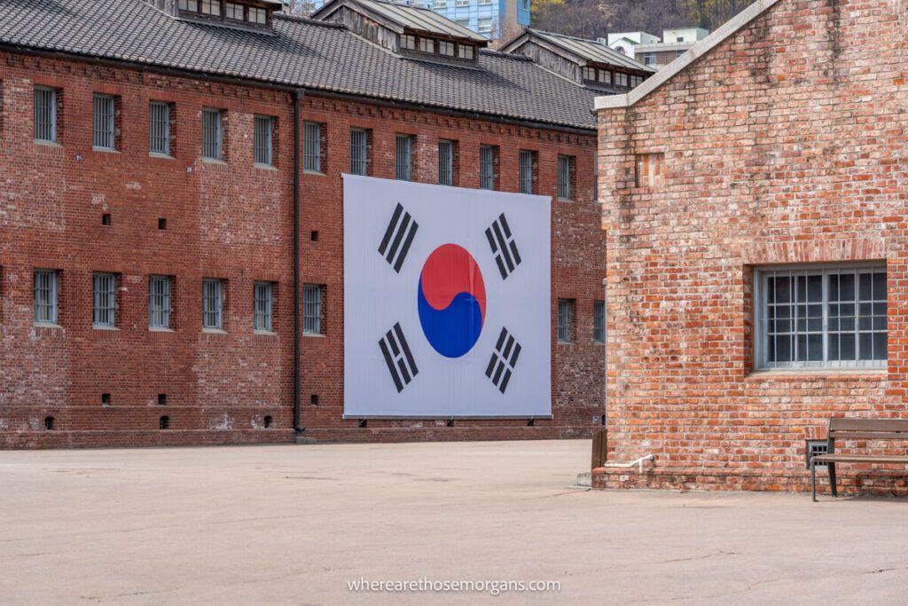 The Korean flag displayed on large brick buildings