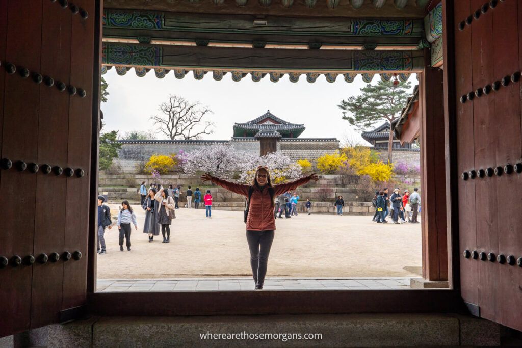 Woman inside a large wooden gate in Seoul