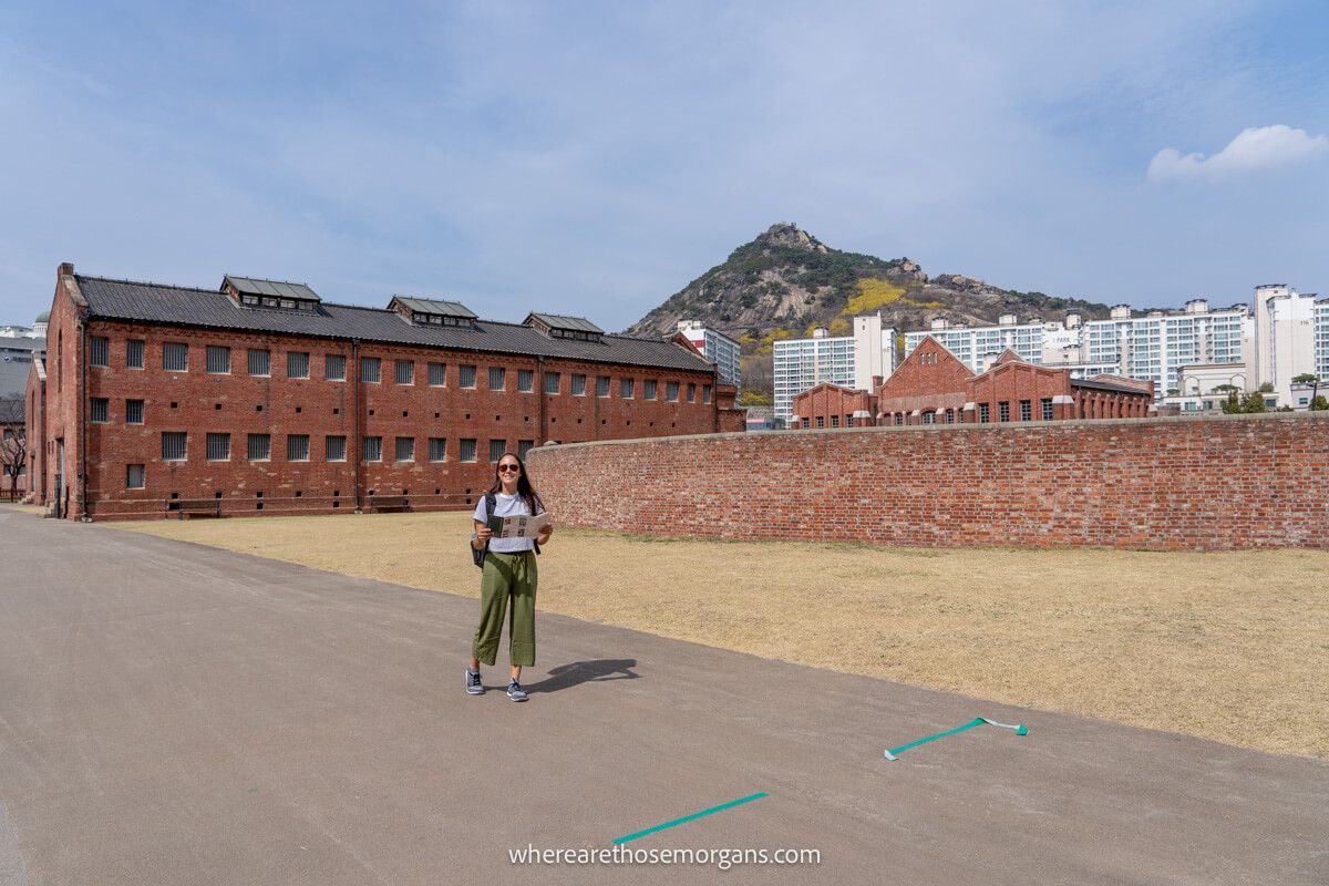 Woman reading an informational brochure for the Seodaemun Prison in Seoul
