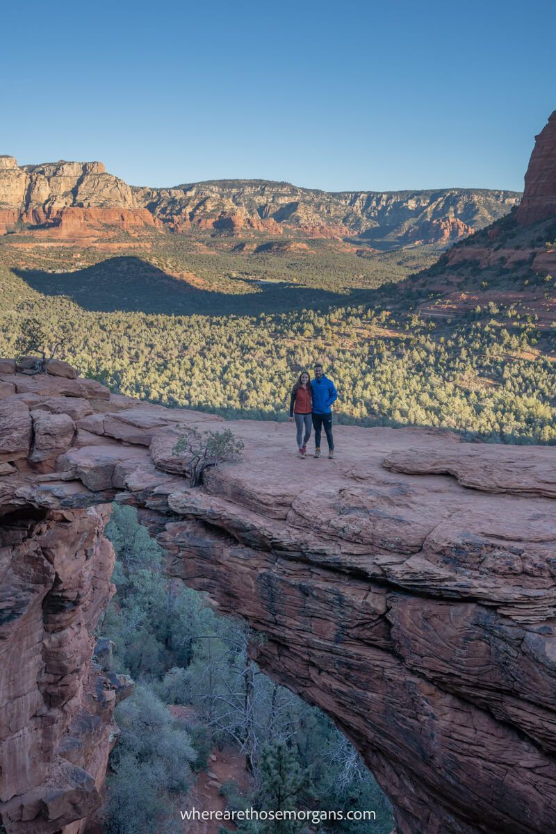 Couple standing together for the famous photo on top of Devils Bridge in Sedona