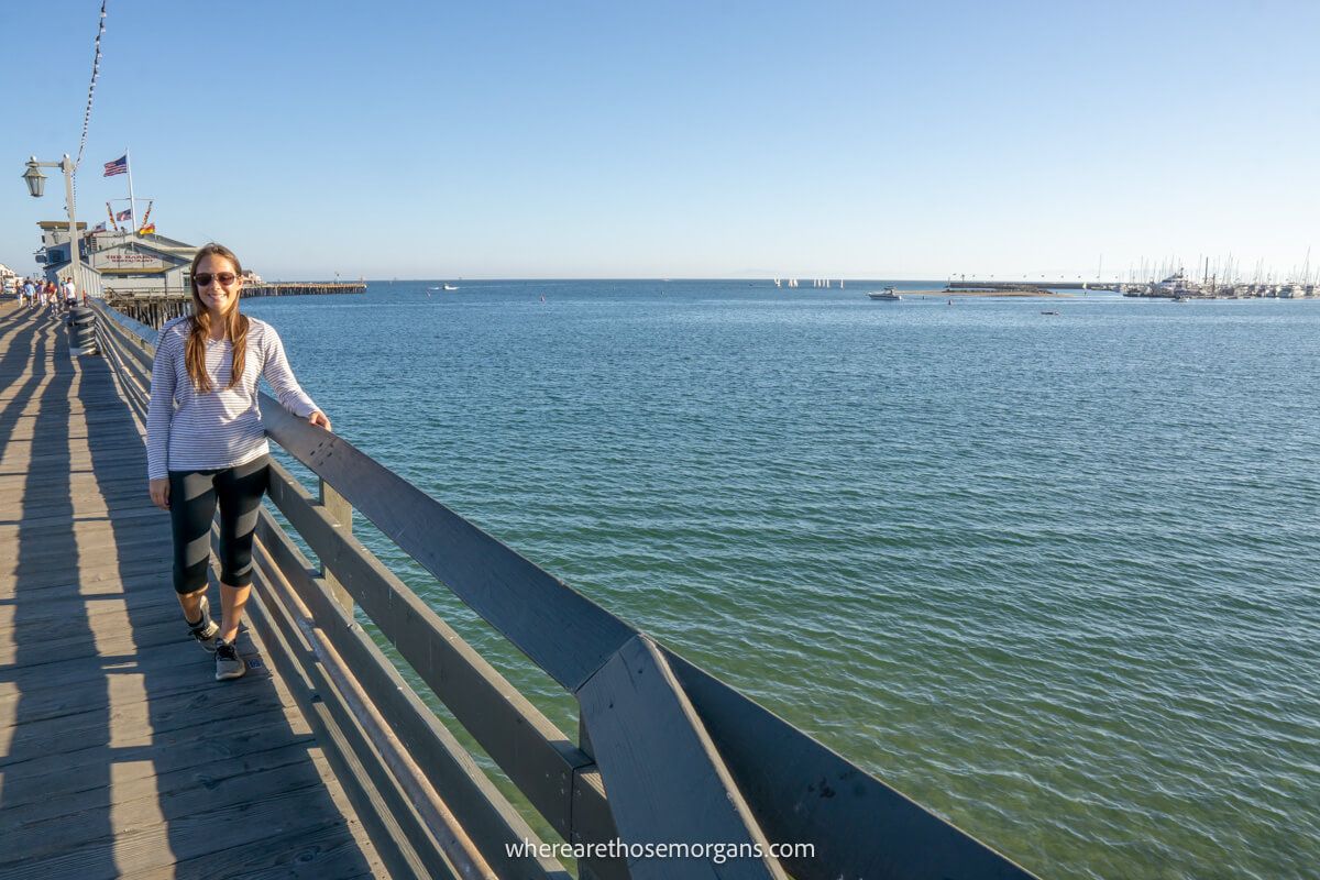 Tourist standing on Santa Barbara Pier overlooking the ocean on a sunny afternoon