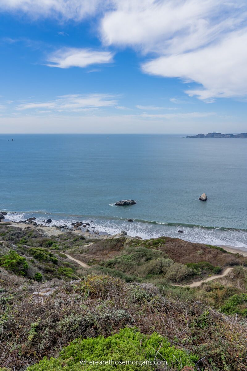 Marshall's Beach near Golden Gate Bridge is with Pacific Ocean in distance walking along beaches is one of the most underrated free things to do in San Francisco CA