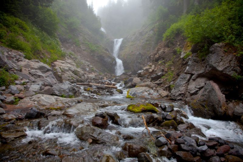 Narrow waterfall at the end of a creek on a misty day