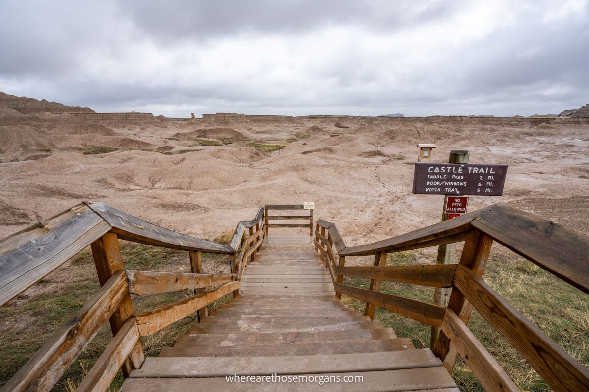 Castle Trailhead wooden steps leading to rocky formations with clouds in the sky