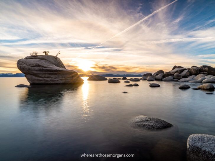 Sunset starburst at Bonsai Rock in Lake Tahoe with clear sky and smooth water