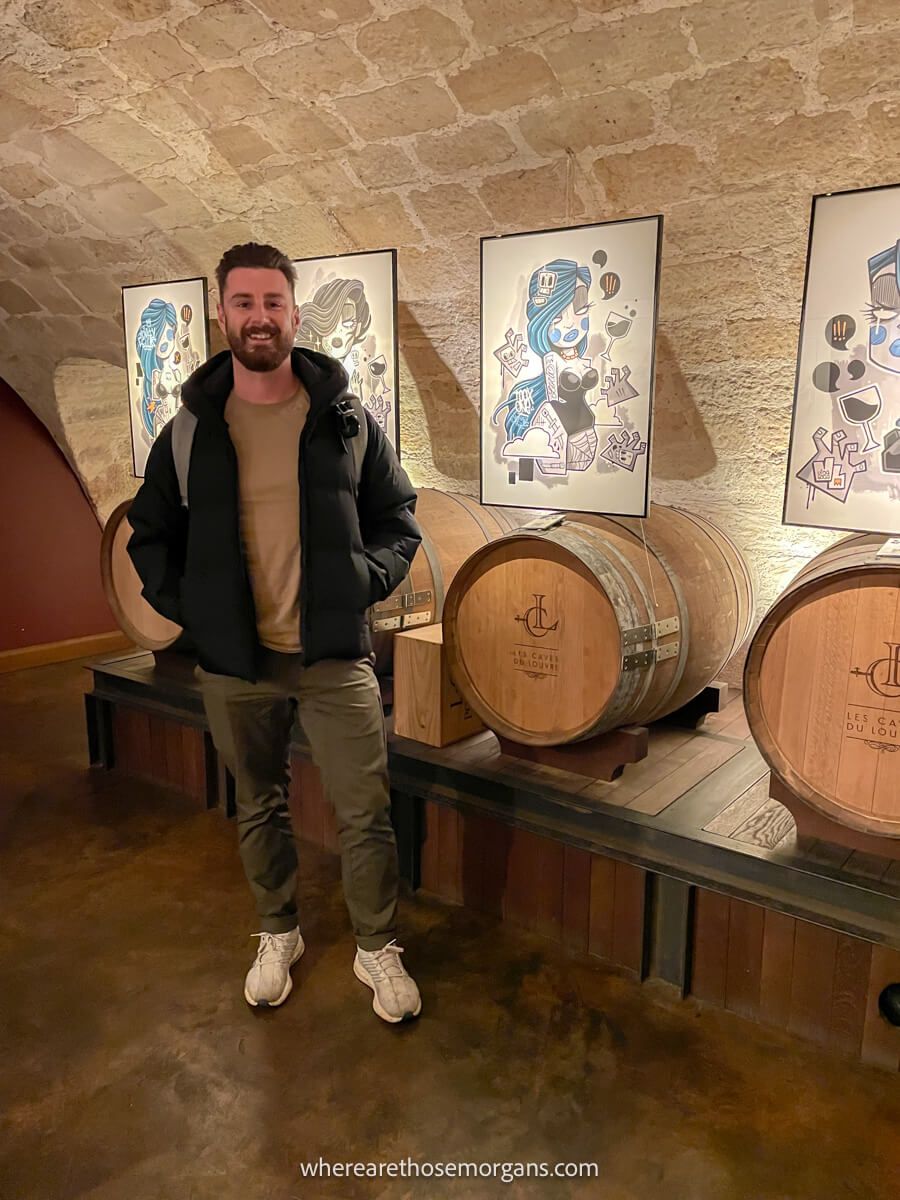 Tourist taking a wine tour in the Caves du Louvre