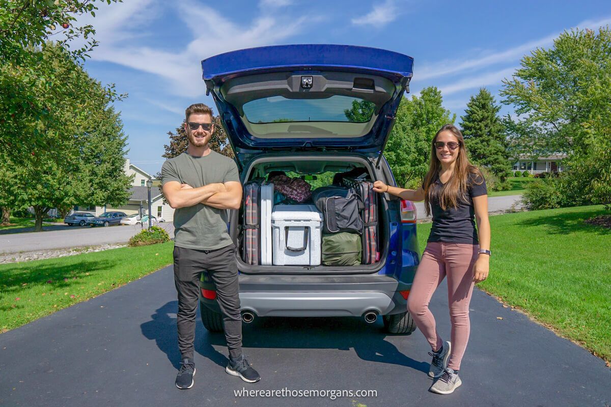 Man and woman packing their Ford SUB for a road trip across the United States