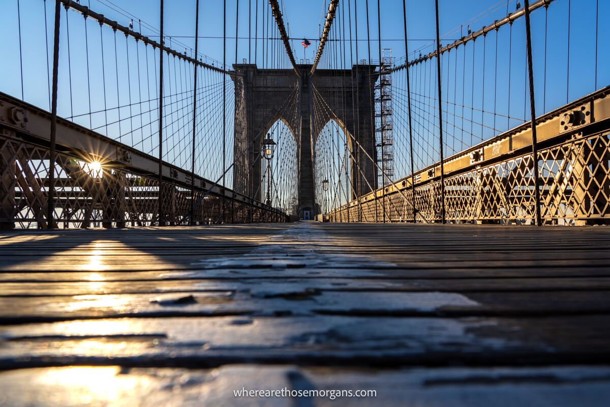 The Brooklyn Bridge in NYC at sunrise with nobody on the walkway and a clear photo