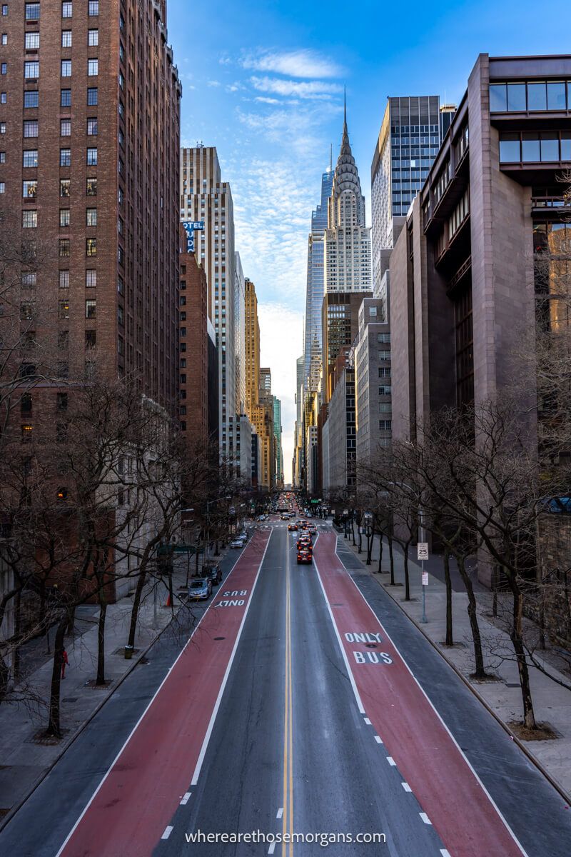 Long road in New York City cutting through blocks of buildings and skyscrapers