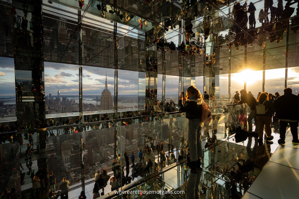 Mirrors and people reflecting at sunset inside Summit One Vanderbilt in New York City