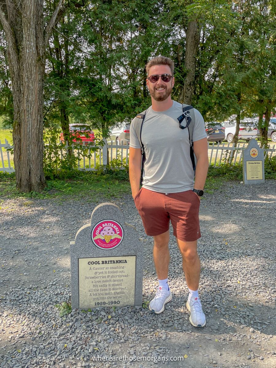 Man standing with the retired flavor of Cool Cool Britannia in Ben and Jerry's flavor graveyard in Waterbury, Vermont