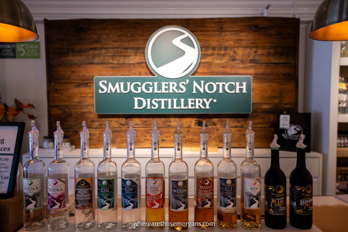 Bottles of alcohol lined up in a row for tasting at the Smugglers' Notch Distillery