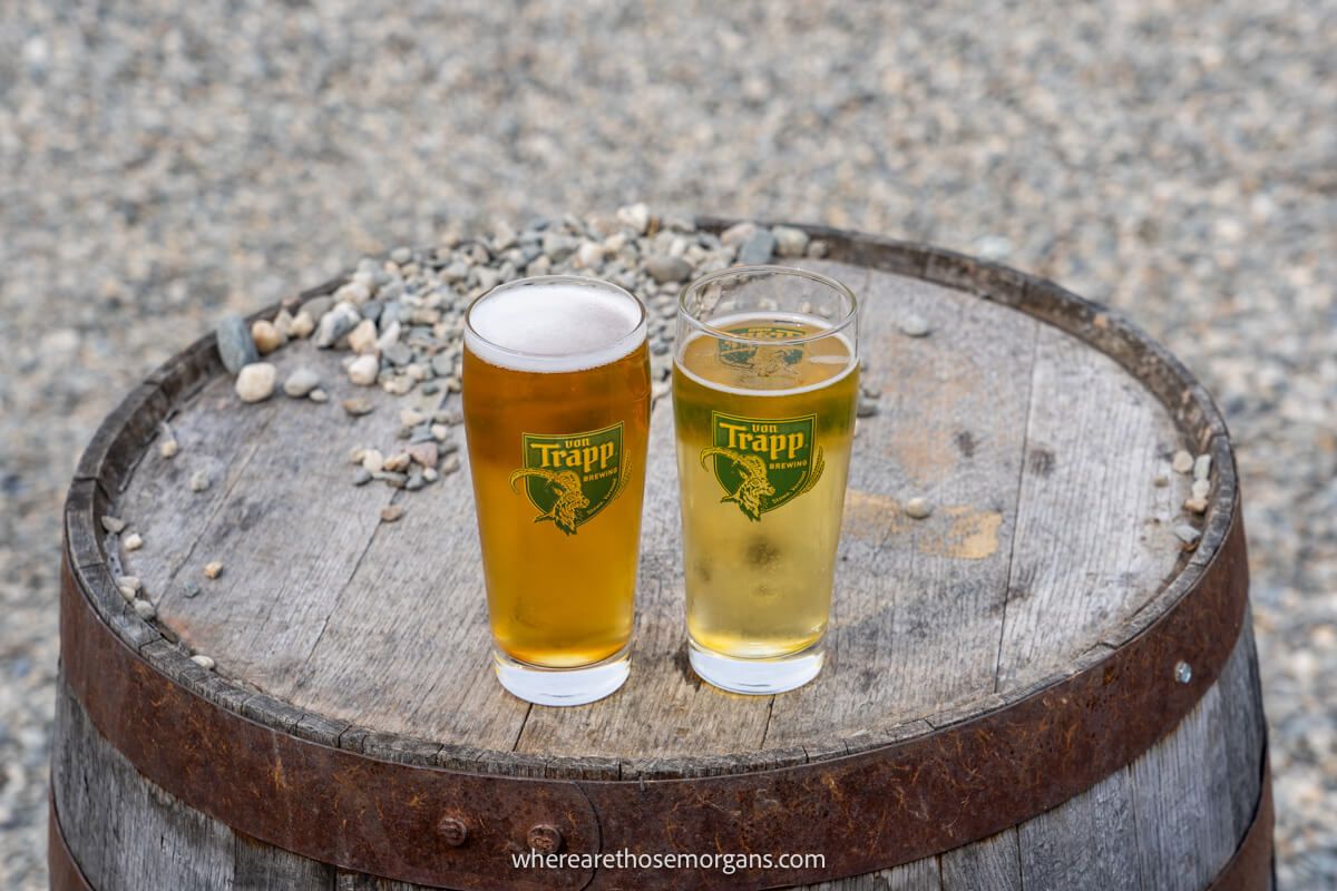 Two beers sitting on a wooden barrel at Von Trapp Brewery