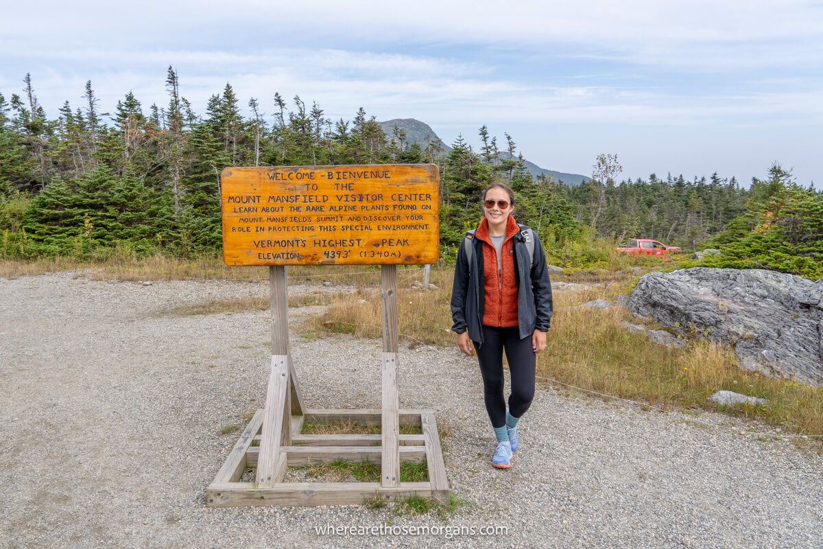 Hiker taking a photo at the top of Mount Mansfield after driving the auto toll road
