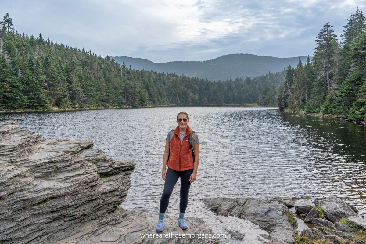 Hiker posing for a photograph at Sterling Pond on a cloudy day