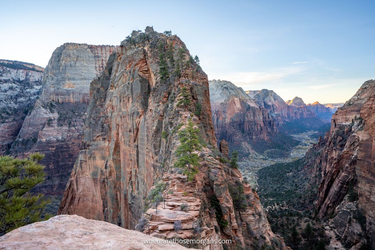 Photo of Angels Landing razor thin shark fin shaped rock formation with no hikers at sunrise in December