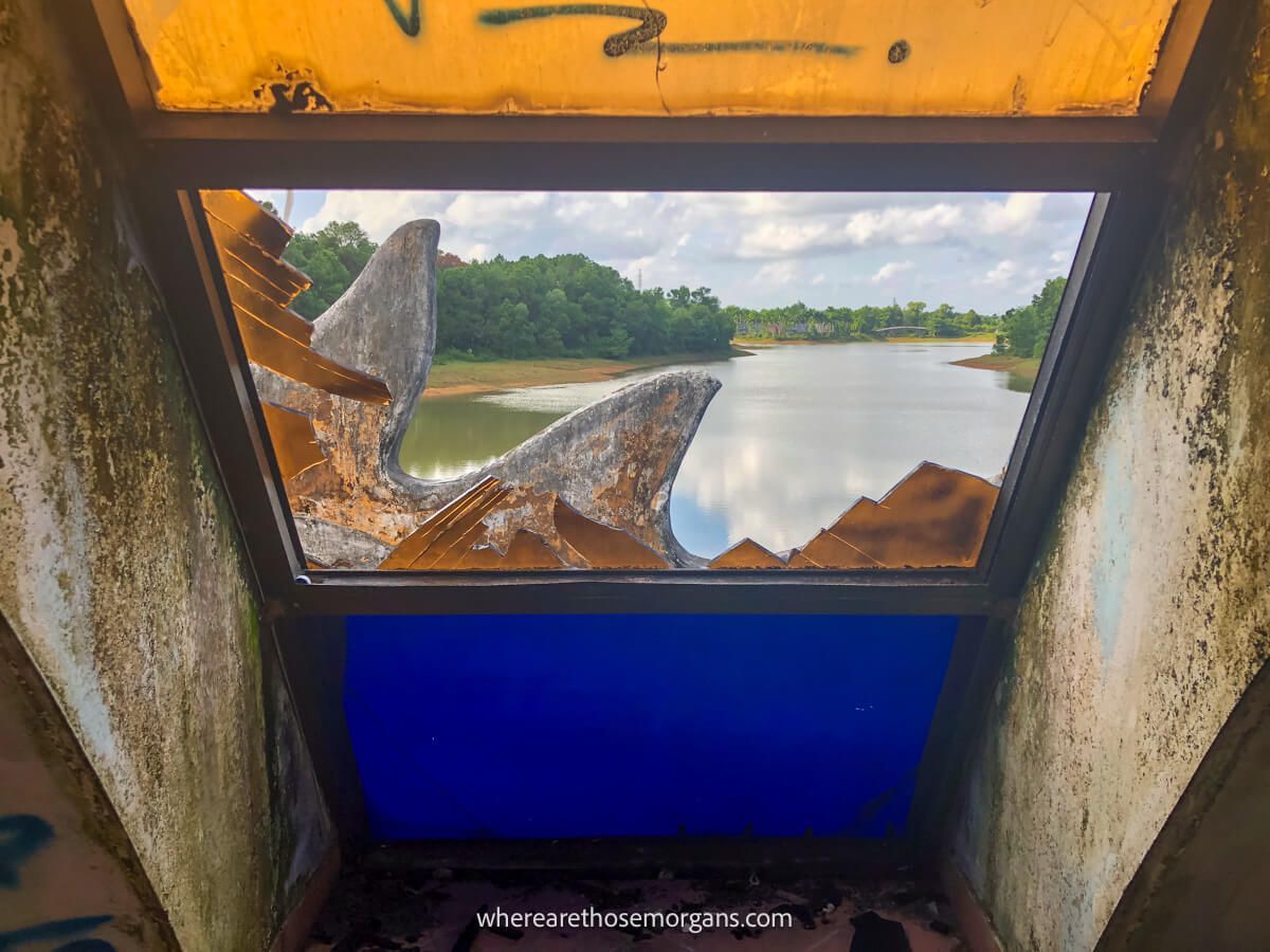 Broken window overlooking a lake in Vietnam