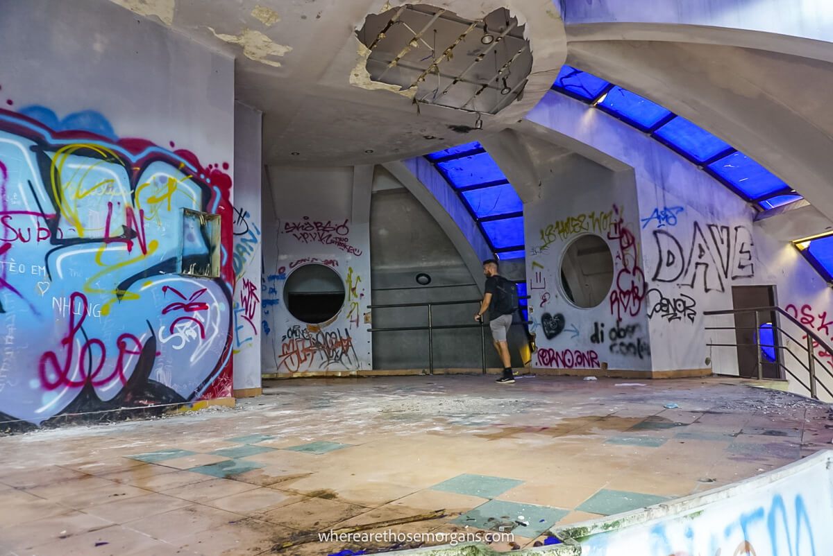 Person walking around the main floor of an old abandoned aquarium in Hue