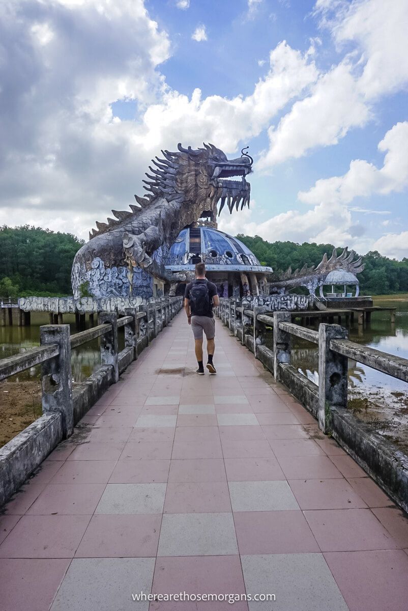 Person walking along a bridge to a dragon shaped aquarium