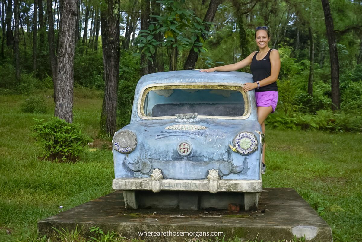 Woman standing on the edge of an old car in Hue, Vietnam