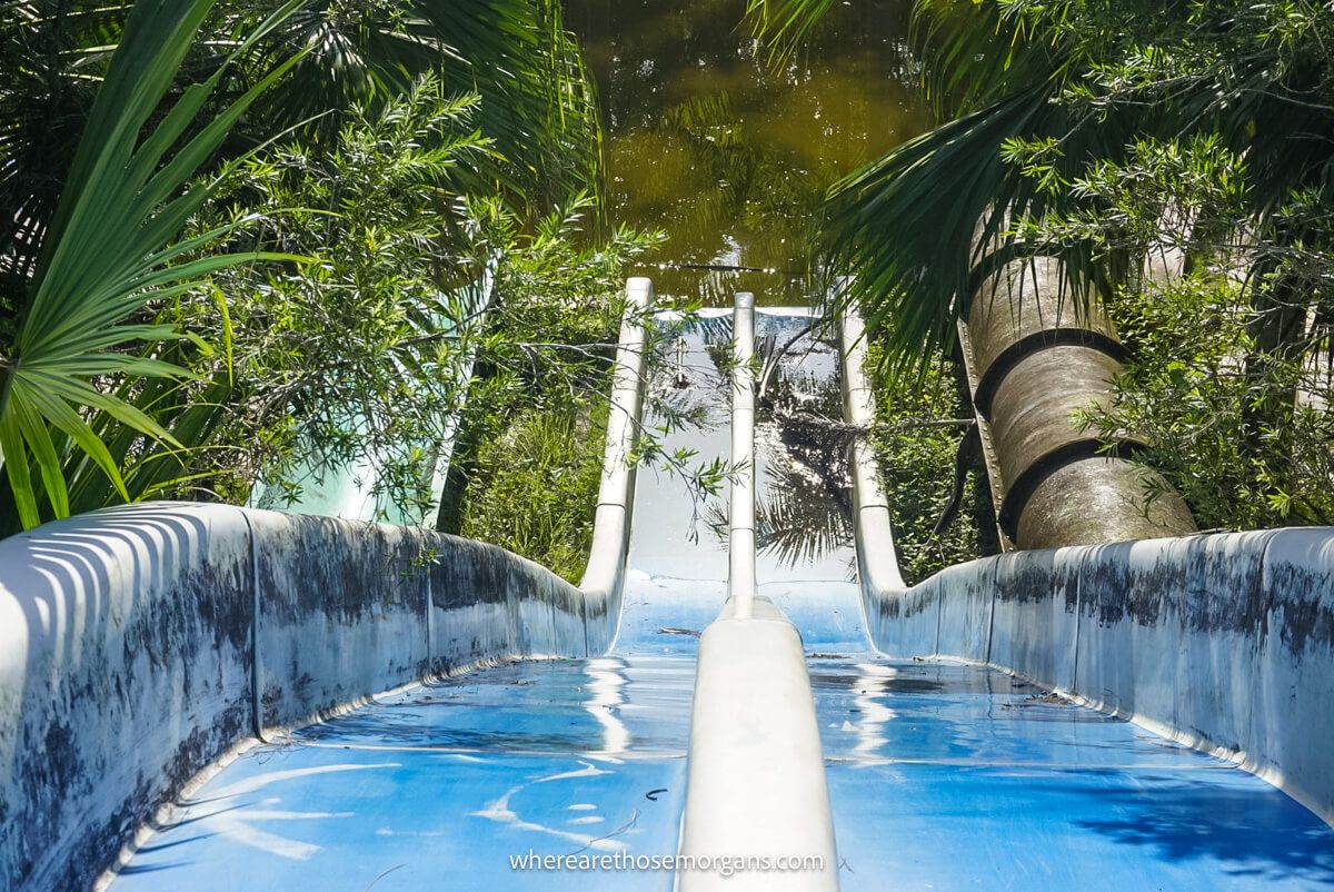 Top of a dual blue and white waterslide ending in a pool of water