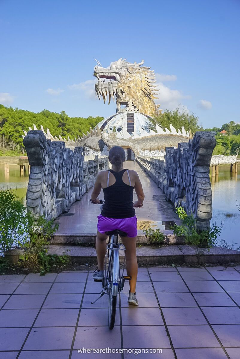 Person on a bike on front of an abandoned aquarium in Hue