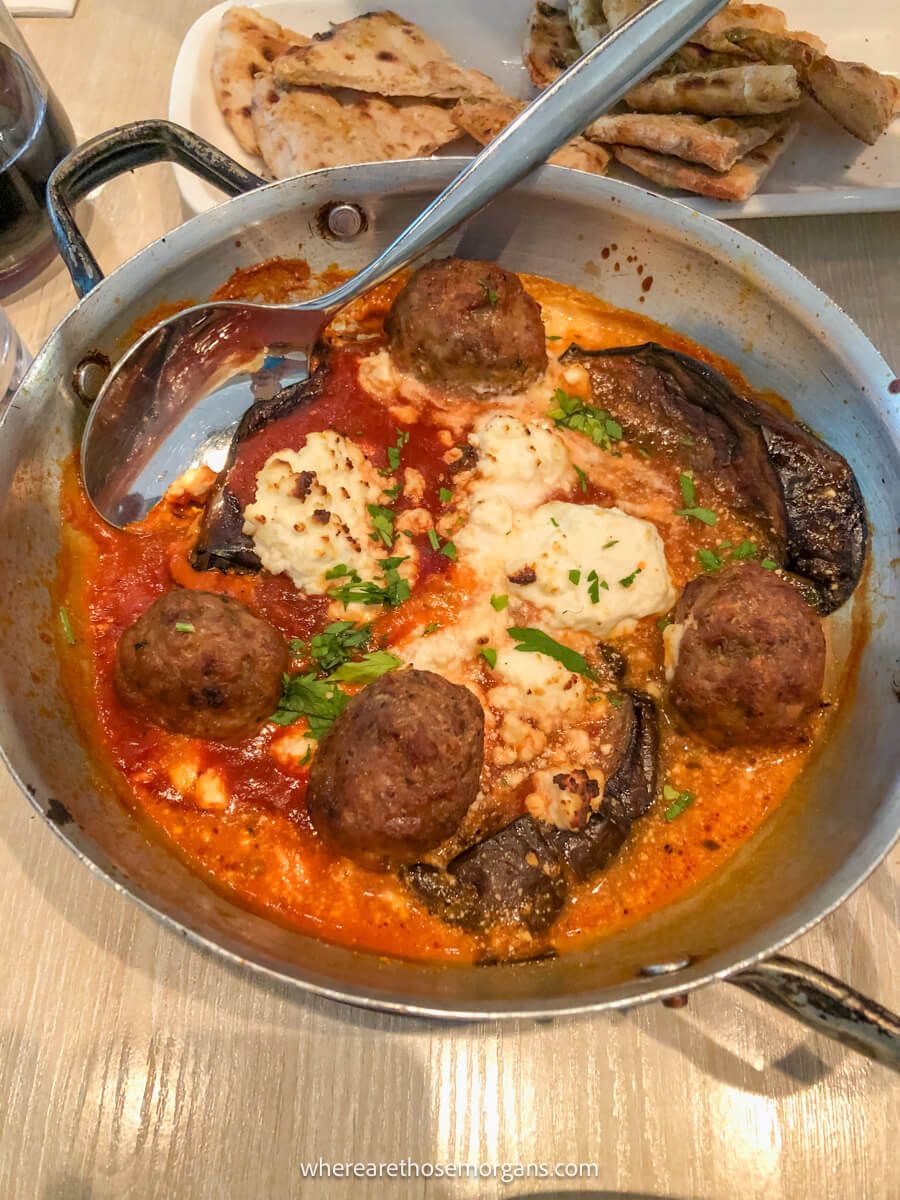 Delicious looking Greek food served in a large bowl with a spoon