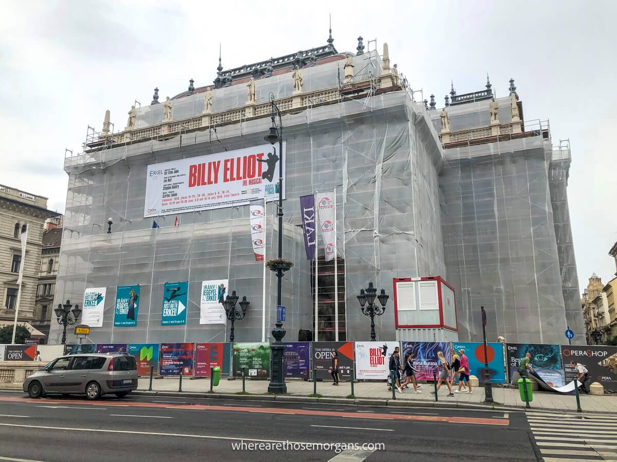 Photo of an opera house in Budapest completely covered in scaffolding and tarpaulin