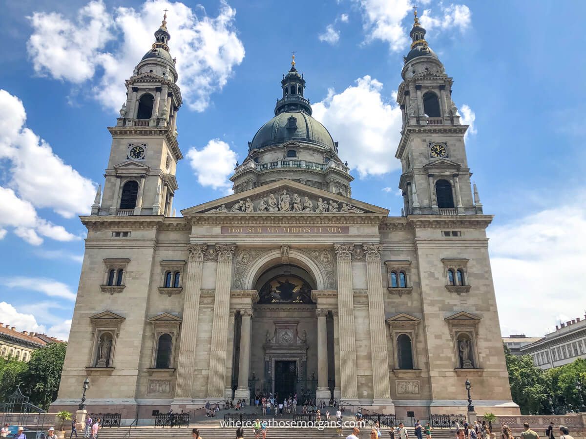 Photo looking at a huge stone basilica with dome at the top on a sunny day