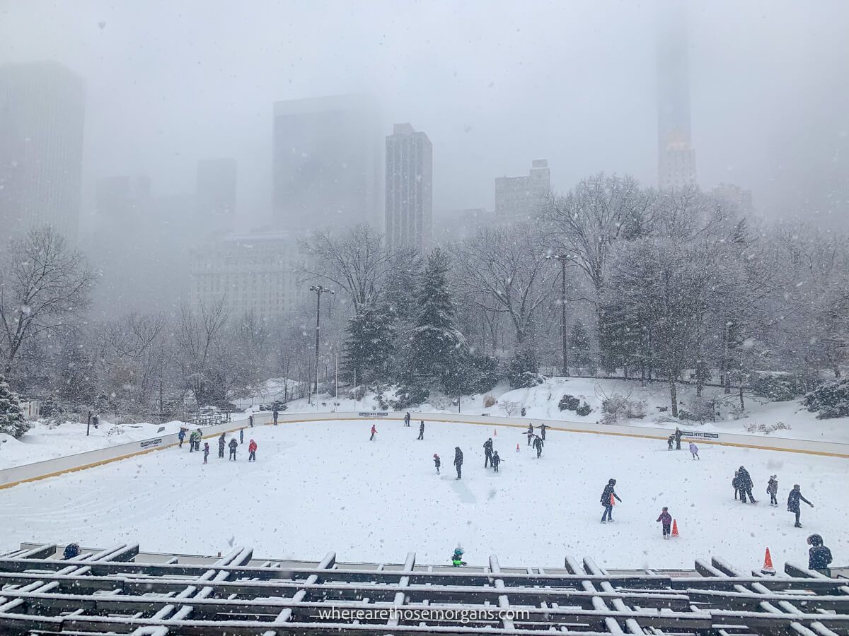 Ice rink in Central Park covered in snow with thick clouds rolling in during the winter