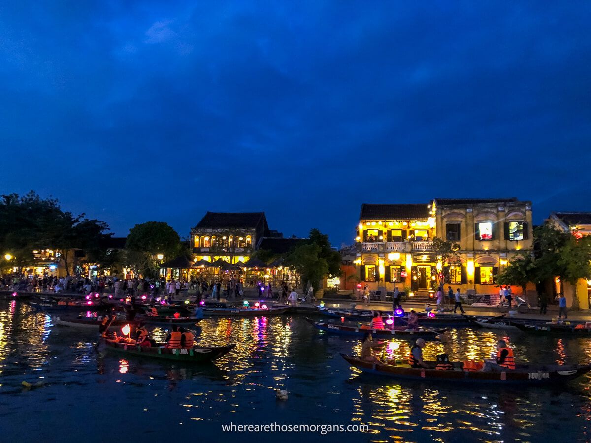 Several boats floating down the river in Hoi An at night