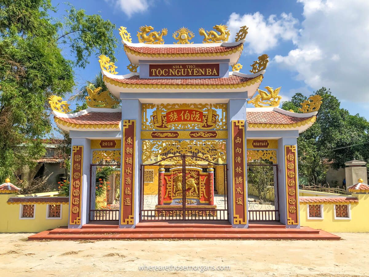 Exterior view of a brightly colored family temple and gate