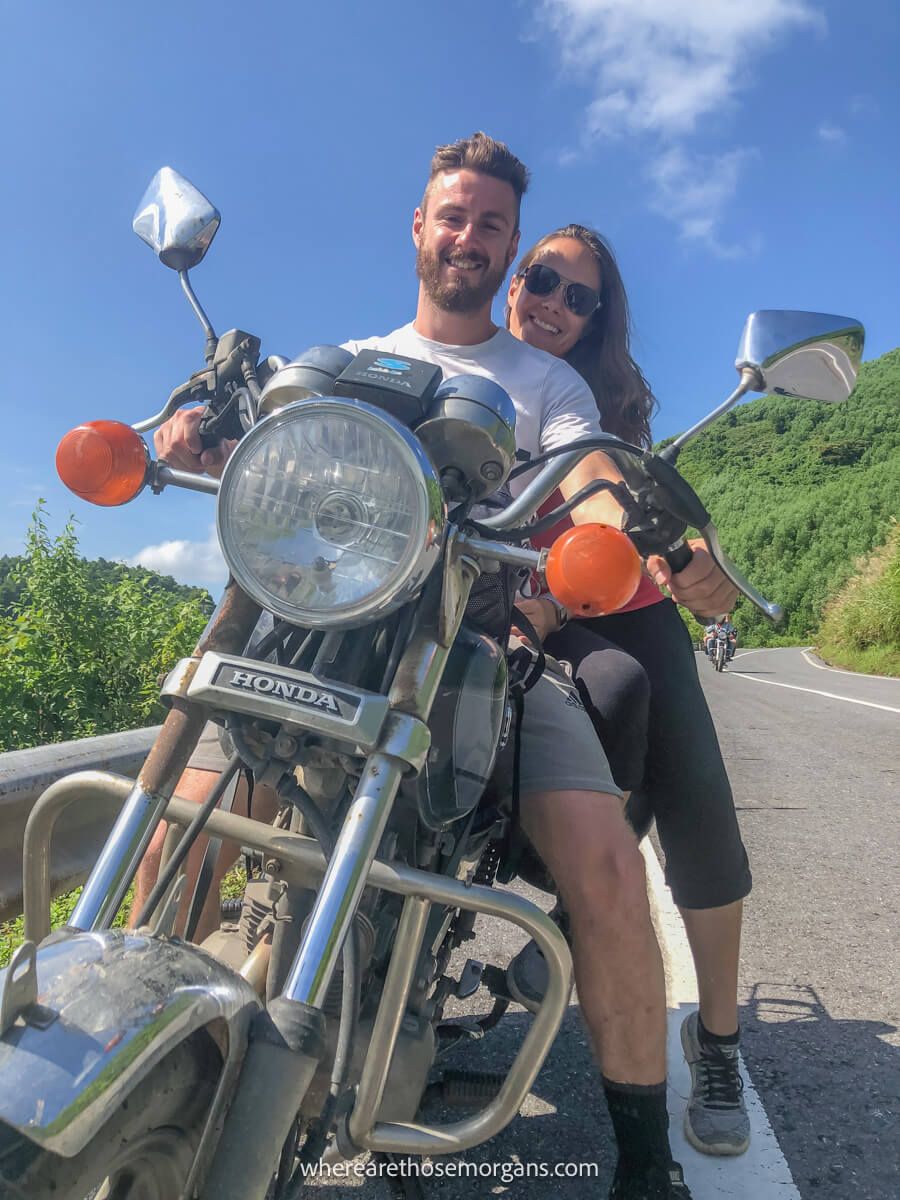 Two people taking a photo on a motorbike