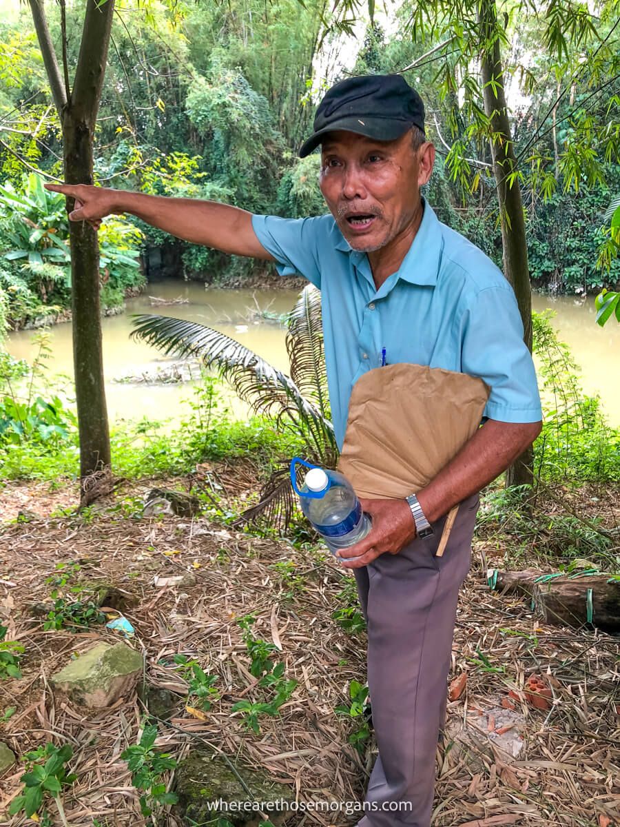 Man pointing to war shrapnel in Vietnam