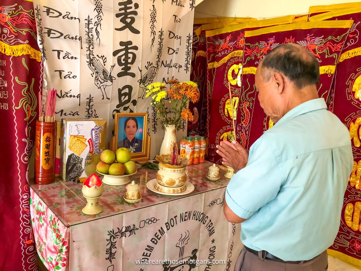 A man saying a prayer for his wife at an alter