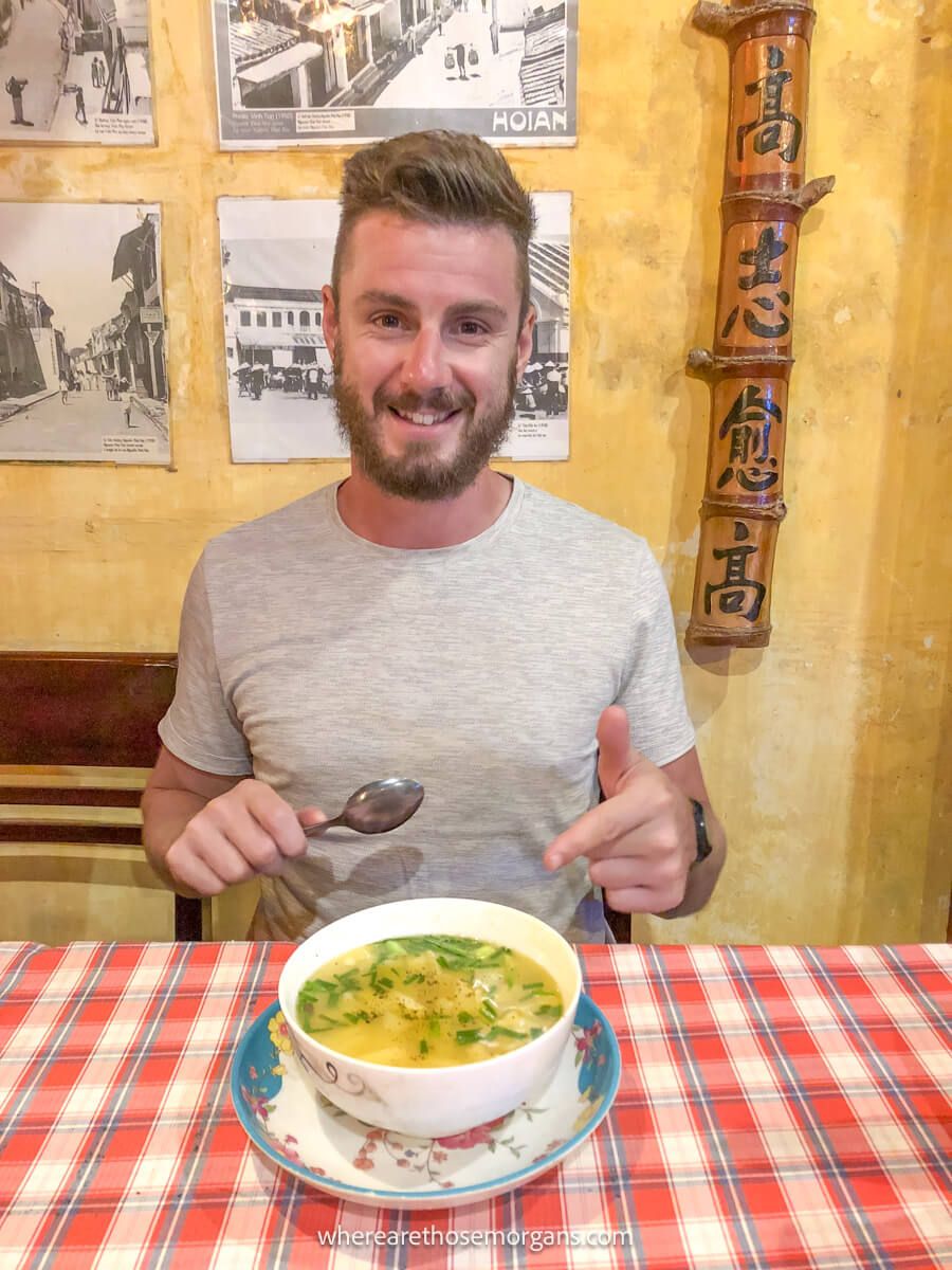 Man about to eat a bowl of soup in Hoi An