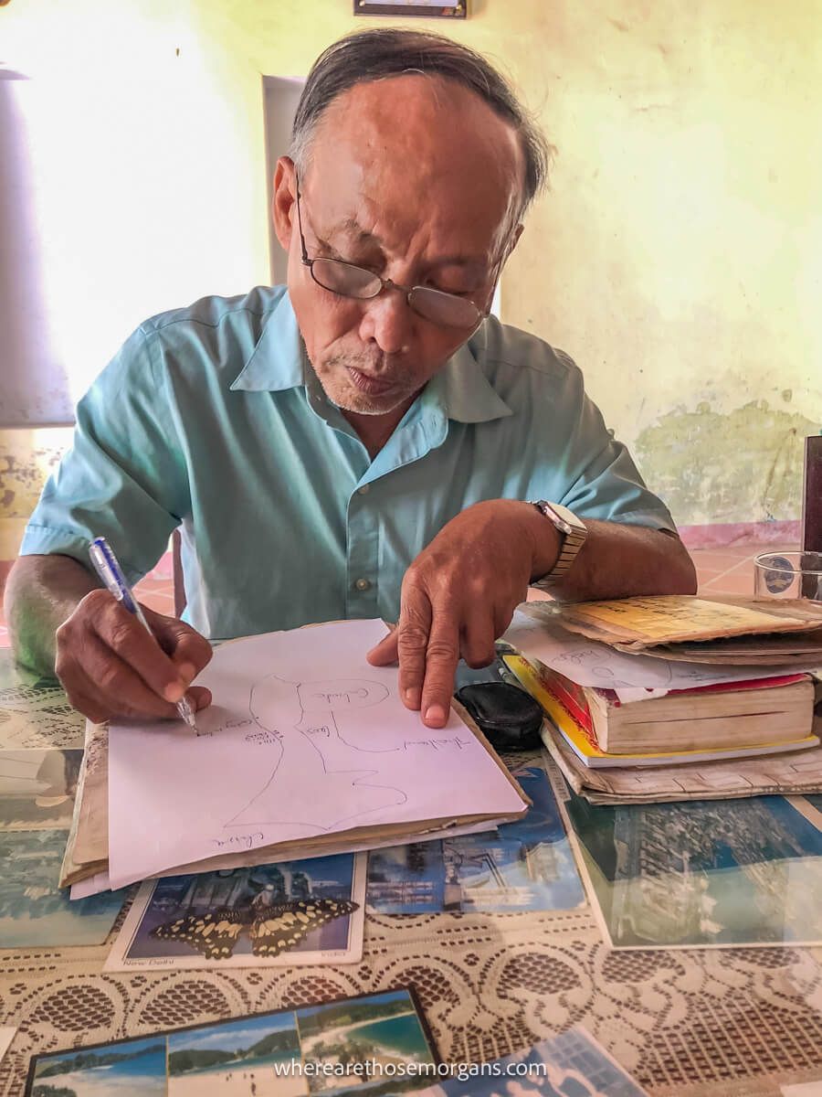 Vietnamese man writing in a notebook