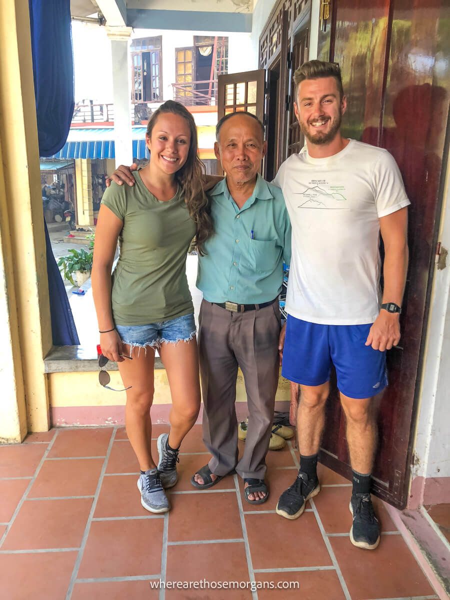 Two tourists taking a photo with a Vietnamese local man