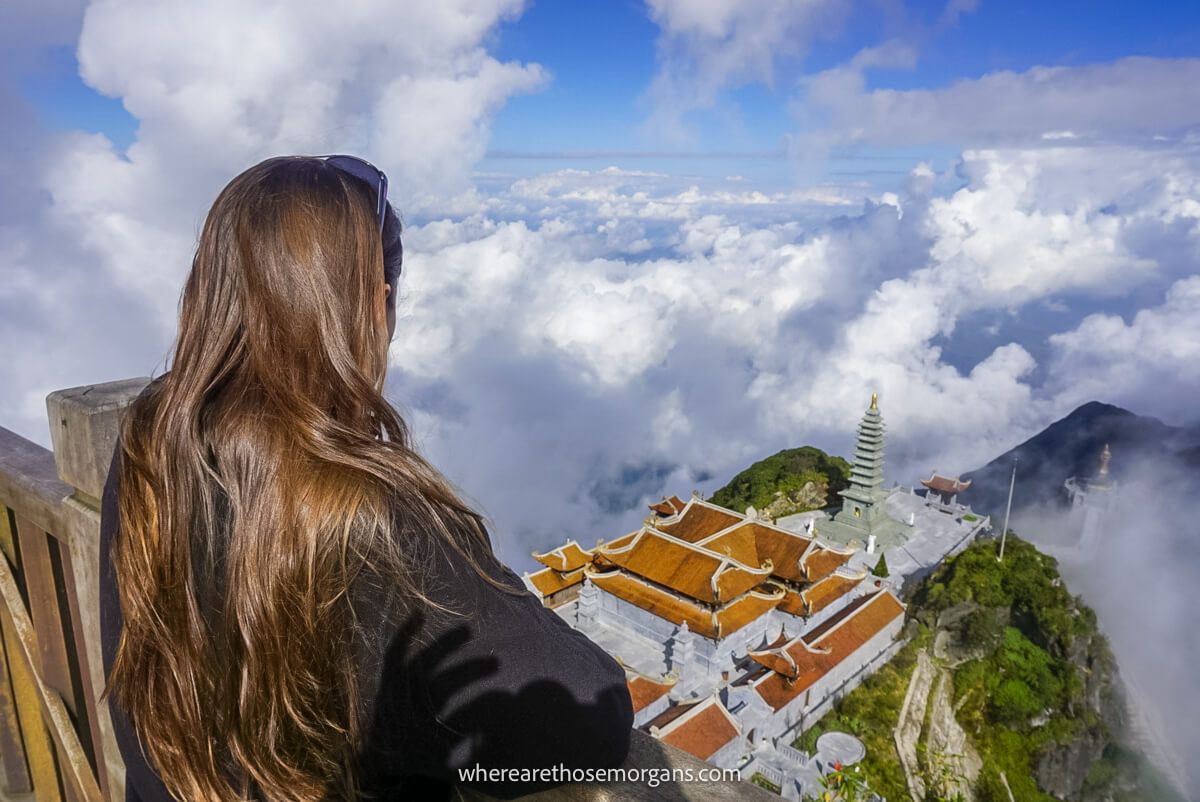 Woman looking down over the beautiful gardens from the summit of Mount Fansipan in Vietnam