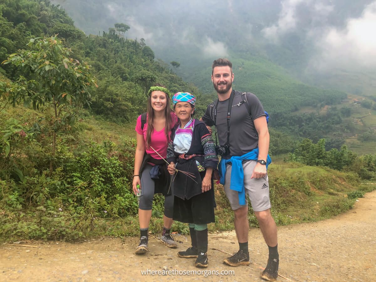 Two people hiking with a woman from the Hmong community northern Vietnam