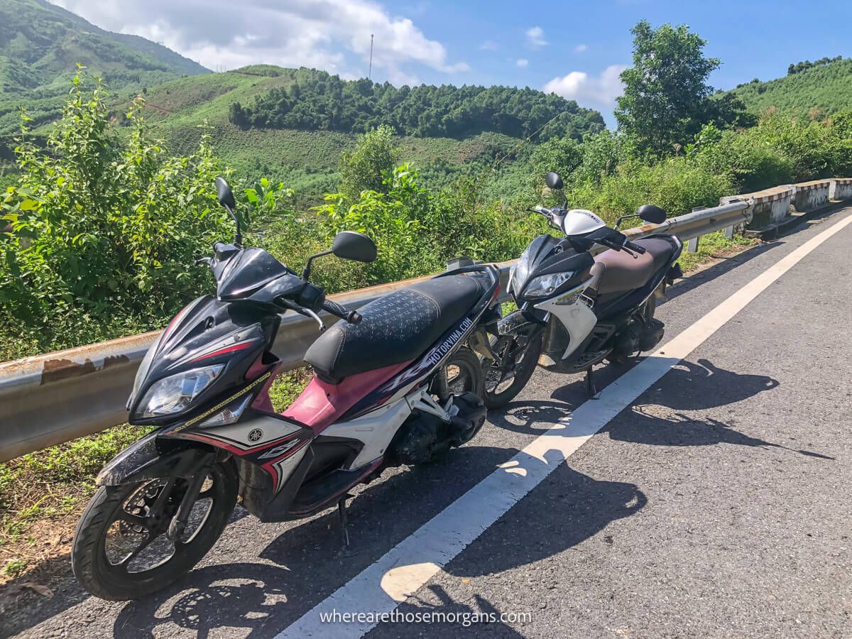 A pair of motorbikes parked along the road