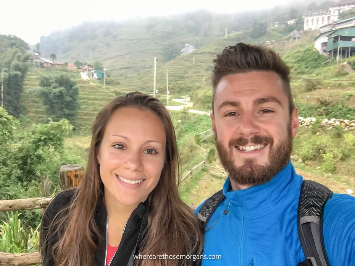 Two people posing for a photo in a small community in Sapa, Vietnam